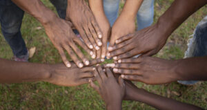 Illustration of hands joining in circle representing philanthropy and global cooperation